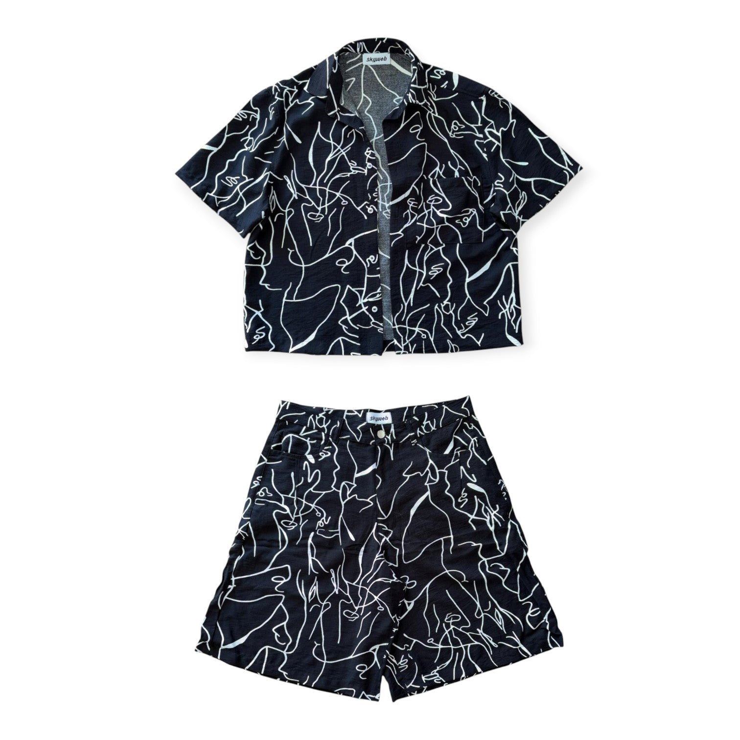 Black and white patterned shirt and shorts set on a white background