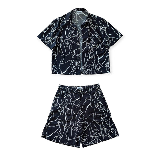 Black and white patterned shirt and shorts set on a white background