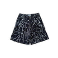 Black shorts with white abstract patterns on a white background
