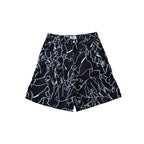 Black shorts with white abstract patterns on a white background