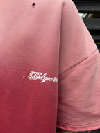 Pink sweatshirt with 'Skyway' logo on sleeve