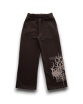 Dark brown wide-leg sweatpants with a white distressed graphic print on the lower right leg, displayed on a clean white background.