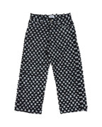 SKYWEB baggy jeans in black and white checkerboard denim with a textured cut and frayed surface and raw hem.