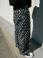 SKYWEB baggy black and white checkerboard denim jeans with raised frayed squares and a raw hem in a streetwear style.