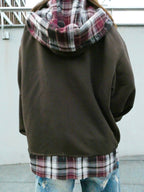Back view of SKYWEB rust oversized zip-up hoodie with burgundy plaid flannel hood lining and hem extension