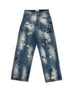 SKYWEB Phantom baggy blue denim jeans with stonewash, paint splatter, and heavy distressing in a relaxed fit.