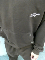 SKYWEB rust oversized hoodie in french terry cotton featuring silver star studs on the kangaroo pocket and logo