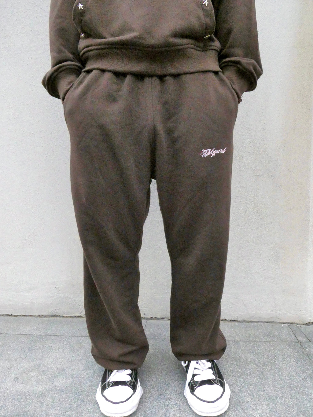 SKYWEB rust wide-leg french terry sweatpants with an elastic waist and embroidered logo on the left thigh
