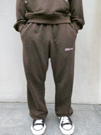 SKYWEB rust wide-leg french terry sweatpants with an elastic waist and embroidered logo on the left thigh