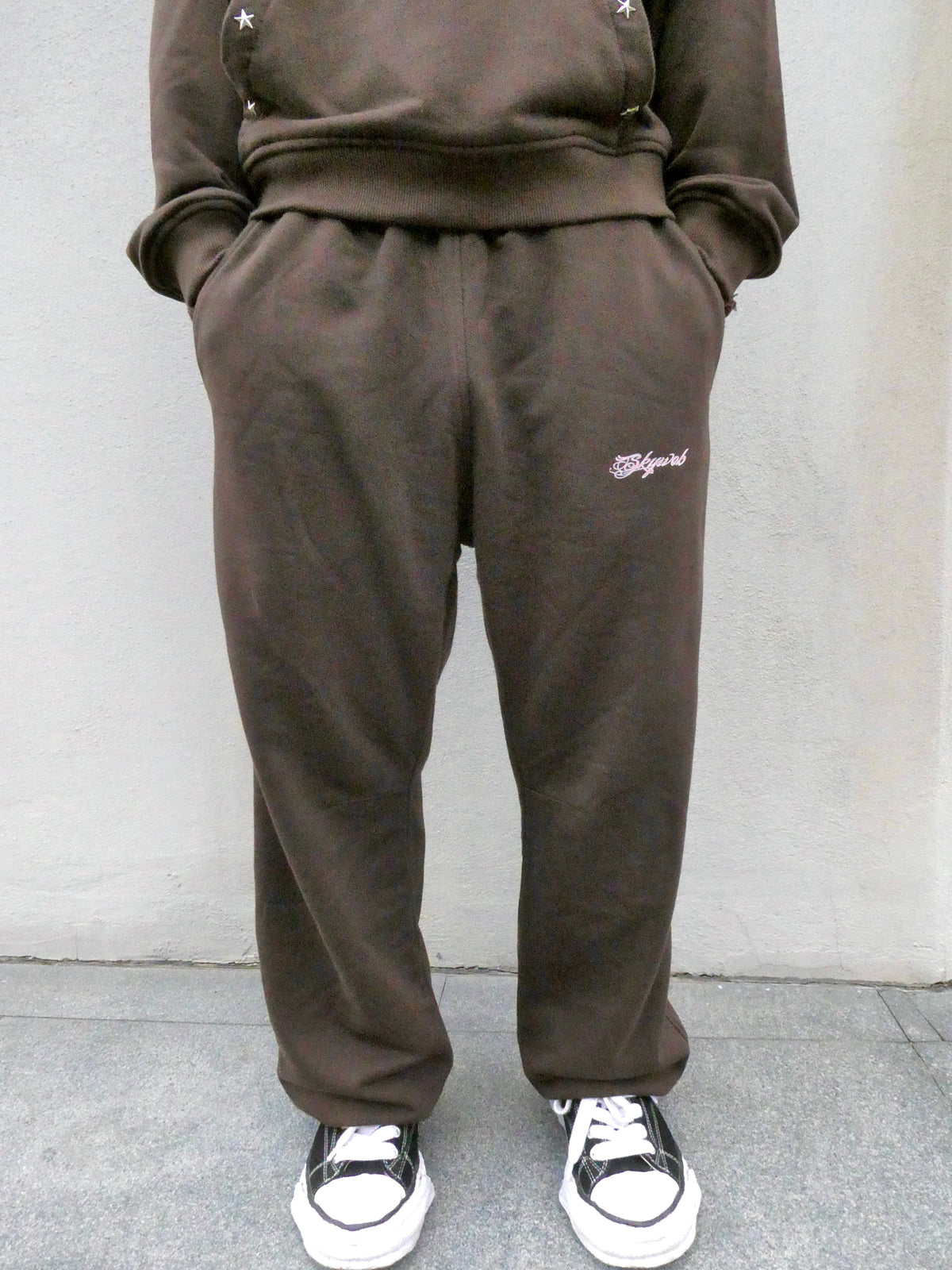 SKYWEB rust wide-leg french terry sweatpants with an elastic waist and embroidered logo on the left thigh